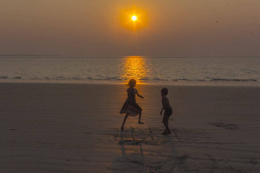 Children playing on the beach at sunset, Mousuni Island